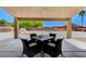 Covered patio with an outdoor table and chairs with view of a dog park with play structures at 7504 Via Sistina St, Las Vegas, NV 89131