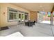 A covered patio with an outdoor table and chairs is an inviting space to gather outside at 7504 Via Sistina St, Las Vegas, NV 89131