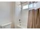 Tile shower over tub with shower curtain and white walls at 7504 Via Sistina St, Las Vegas, NV 89131