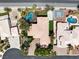 An aerial view showcases an estate with a pool, spa, mature trees, and manicured landscaping at 7520 Captains Harbor Dr, Las Vegas, NV 89117