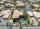 Aerial view of a property with a private pool, lush landscaping, and a tennis court at 7520 Captains Harbor Dr, Las Vegas, NV 89117