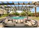 Beautiful backyard featuring a sparkling swimming pool, a cozy seating area, and lush greenery at 7520 Captains Harbor Dr, Las Vegas, NV 89117