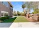 The backyard features a built in BBQ, grass area, and covered patio at 7520 Captains Harbor Dr, Las Vegas, NV 89117