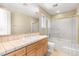 Well-lit bathroom features tile countertop, wooden cabinets, and shower-tub combination at 7520 Captains Harbor Dr, Las Vegas, NV 89117