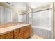 Updated bathroom featuring tile countertop, wooden cabinets, and a shower-tub combination at 7520 Captains Harbor Dr, Las Vegas, NV 89117