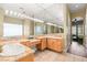 Bathroom featuring a dual vanity with granite countertops and glass block window at 7520 Captains Harbor Dr, Las Vegas, NV 89117