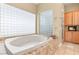 Bright bathroom with a soaking tub and window providing natural light at 7520 Captains Harbor Dr, Las Vegas, NV 89117