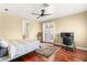 Bright bedroom boasts hardwood floors and a ceiling fan and provides a dedicated workspace at 7520 Captains Harbor Dr, Las Vegas, NV 89117