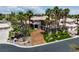 Majestic home features a meticulously landscaped yard, tall palm trees, and a circular driveway entrance at 7520 Captains Harbor Dr, Las Vegas, NV 89117