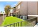 View of the home's side with a manicured lawn and multiple AC units at 7520 Captains Harbor Dr, Las Vegas, NV 89117