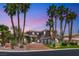 Elegant two-story home showcasing a well-manicured front yard, circular driveway and mature landscaping at 7520 Captains Harbor Dr, Las Vegas, NV 89117