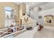 Elegant foyer with a stunning chandelier, and a beautiful staircase with wood steps at 7520 Captains Harbor Dr, Las Vegas, NV 89117