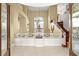 Grand foyer with soaring ceilings, a decorative chandelier, and an elegant staircase at 7520 Captains Harbor Dr, Las Vegas, NV 89117