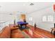 Game room with pool table, hardwood floors, wet bar, and a comfortable leather couch at 7520 Captains Harbor Dr, Las Vegas, NV 89117