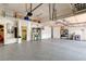 Spacious garage with epoxy floors, overhead storage, and built-in cabinets offers ample storage space at 7520 Captains Harbor Dr, Las Vegas, NV 89117