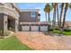 Home exterior showing three-car garage with stamped concrete driveway at 7520 Captains Harbor Dr, Las Vegas, NV 89117