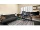 Comfortable office space with multiple monitors, modern desk, and cozy seating area on dark floors at 7520 Captains Harbor Dr, Las Vegas, NV 89117