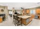 Spacious kitchen with granite counters, center island, stainless appliances, and dining area at 7520 Captains Harbor Dr, Las Vegas, NV 89117