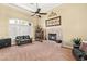 Cozy living room featuring a fireplace, comfortable seating, and ample natural light at 7520 Captains Harbor Dr, Las Vegas, NV 89117