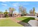 Outdoor kitchen area with built-in brick BBQ and patio at 7520 Captains Harbor Dr, Las Vegas, NV 89117