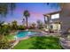 Backyard pool with manicured lawn, spa, and outdoor seating, perfect for entertaining at 7520 Captains Harbor Dr, Las Vegas, NV 89117