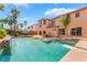 Enjoy the expansive pool with diving board, covered patio, and lush landscaping in this private backyard at 7526 Gossamer Wind St, Las Vegas, NV 89139