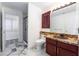 Bathroom featuring a vanity with granite countertop, marble floors, and a glass shower at 7526 Gossamer Wind St, Las Vegas, NV 89139