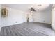 Large bedroom with gray wood floors, neutral walls, fan and lots of natural light at 7526 Gossamer Wind St, Las Vegas, NV 89139