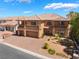 Elegant two-story home with a tile roof, manicured landscaping, and a three-car garage at 7526 Gossamer Wind St, Las Vegas, NV 89139