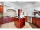 Open kitchen featuring custom cabinets, stainless steel appliances, and a central island at 7526 Gossamer Wind St, Las Vegas, NV 89139