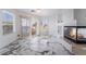 Bright living room with sliding door, fireplace, and marble tile floor at 7526 Gossamer Wind St, Las Vegas, NV 89139