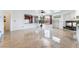 Open-concept living room boasts glossy tile floors, a fireplace, and views of the backyard at 7526 Gossamer Wind St, Las Vegas, NV 89139