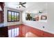 Bright living room with hardwood floors, ceiling fan, large window, and open view to kitchen at 7526 Gossamer Wind St, Las Vegas, NV 89139