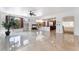 Expansive living area with fireplace, lush indoor plant, and access to the modern kitchen at 7526 Gossamer Wind St, Las Vegas, NV 89139