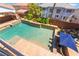 A stunning backyard pool includes features like built-in bar seating and a waterfall spa at 7526 Gossamer Wind St, Las Vegas, NV 89139