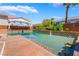 Backyard oasis with a large pool, covered patio, mature palm trees, and ample deck space for entertaining at 7526 Gossamer Wind St, Las Vegas, NV 89139