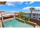 The backyard pool features palm trees, a waterfall spa, and a covered patio area at 7526 Gossamer Wind St, Las Vegas, NV 89139