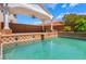Resort style backyard featuring a large pool with lion's head spouts, a covered patio, and lush landscaping at 7526 Gossamer Wind St, Las Vegas, NV 89139