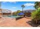 Backyard pool with patio, waterfall spa, a covered patio and lush tropical landscaping at 7526 Gossamer Wind St, Las Vegas, NV 89139