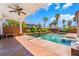 Outdoor living at its finest with a covered patio overlooking a sparkling pool and well-manicured backyard at 7526 Gossamer Wind St, Las Vegas, NV 89139