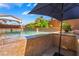 Enjoy this captivating view of a large swimming pool, complete with a covered patio and luxurious tile design at 7526 Gossamer Wind St, Las Vegas, NV 89139