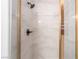 Shower featuring white marble tile, glass doors, and bronze hardware at 7526 Gossamer Wind St, Las Vegas, NV 89139