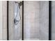 A close up of the shower, highlighting the marble tiles and modern showerhead at 7526 Gossamer Wind St, Las Vegas, NV 89139
