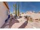 Inviting backyard with rock landscaping, outdoor seating, and tall trees offer a relaxing setting at 7815 Windward Rd, Las Vegas, NV 89147