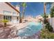 Beautiful pool area with rock surround and lush landscaping, perfect for outdoor entertaining at 7815 Windward Rd, Las Vegas, NV 89147