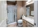 This bathroom has a shower with glass doors, sink, and white toilet at 7815 Windward Rd, Las Vegas, NV 89147