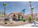 Beautiful home exterior with manicured landscaping, desert plants, and a well-maintained lawn at 7815 Windward Rd, Las Vegas, NV 89147