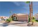 Charming single-story home with tile roof, desert landscaping, and a two-car garage at 7815 Windward Rd, Las Vegas, NV 89147