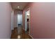 A clean hallway features hardwood floors and leads to various rooms in the house at 7815 Windward Rd, Las Vegas, NV 89147