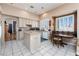Bright kitchen boasts an island, breakfast nook, and stainless steel appliances, ready for meal prep at 7815 Windward Rd, Las Vegas, NV 89147
